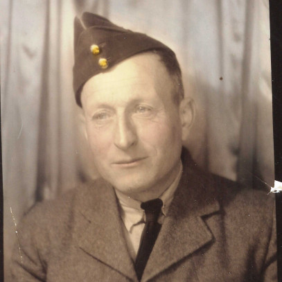 Sepia toned photo. Headshot of an elderly Gaspard Chavarie in his Second World War uniform. Lines on his face are visible and someone has written "Daddy" on the top of the photo.