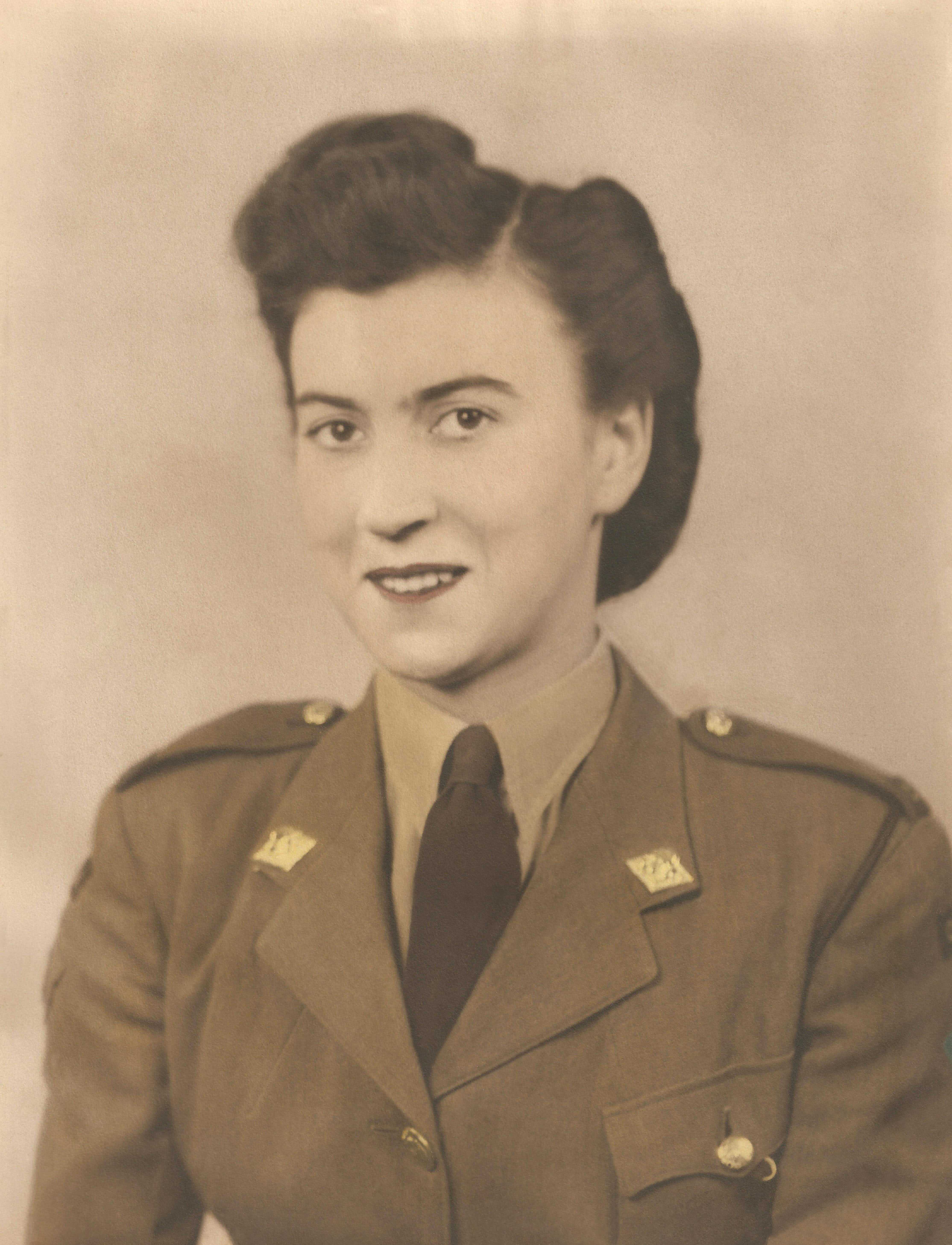 Sepia headshot of a young women in Canadian Women's Army Corps uniform.