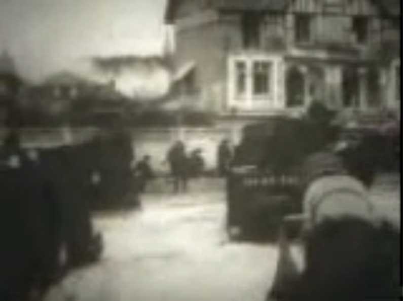 Black and white video footage of soldiers in a boat. Further descriptive details in transcription.